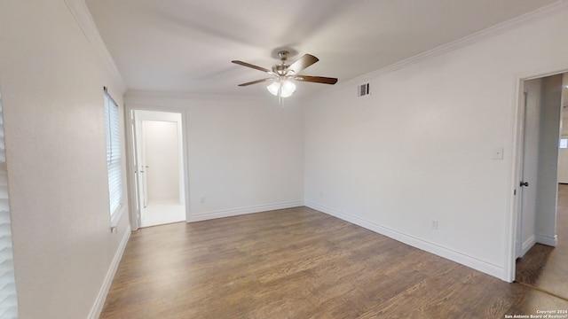 unfurnished room featuring dark wood-type flooring, crown molding, and ceiling fan