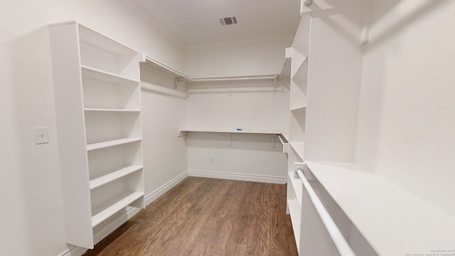 spacious closet with dark hardwood / wood-style floors