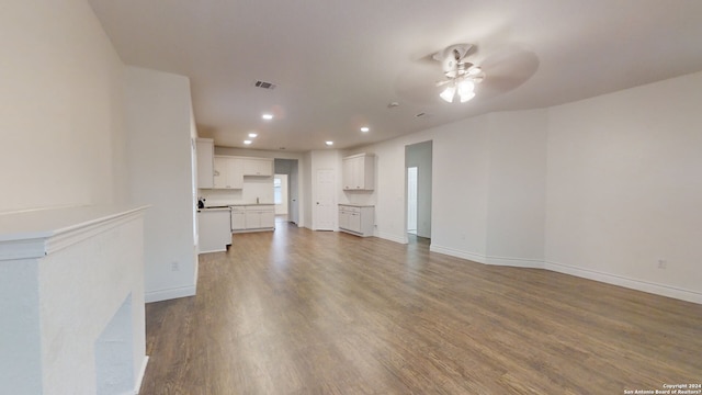 unfurnished living room featuring hardwood / wood-style floors and ceiling fan