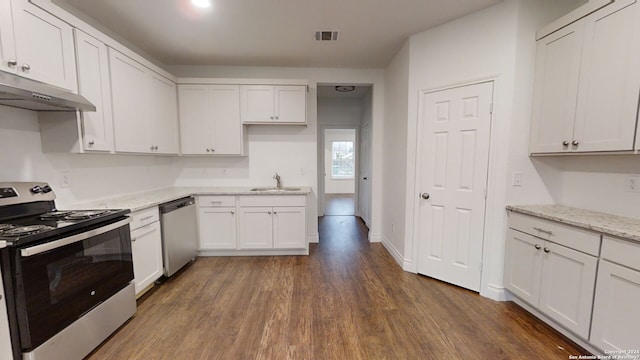 kitchen with white cabinetry, dark hardwood / wood-style floors, appliances with stainless steel finishes, sink, and light stone counters