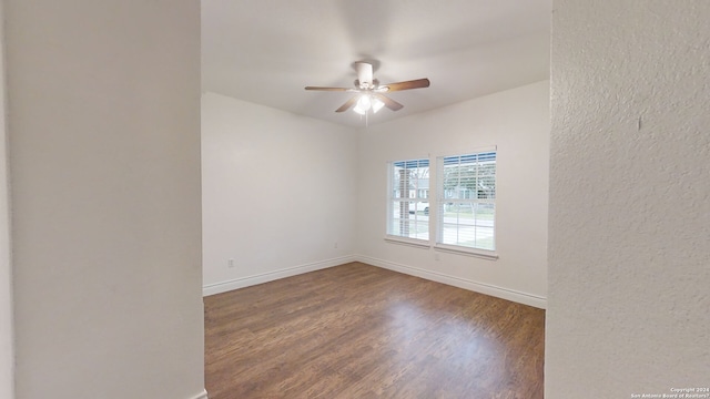 unfurnished room with ceiling fan and dark hardwood / wood-style floors