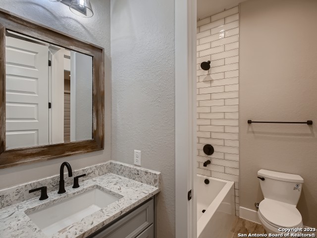 bathroom featuring hardwood / wood-style flooring, toilet, and vanity