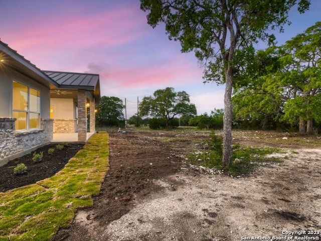 view of yard at dusk