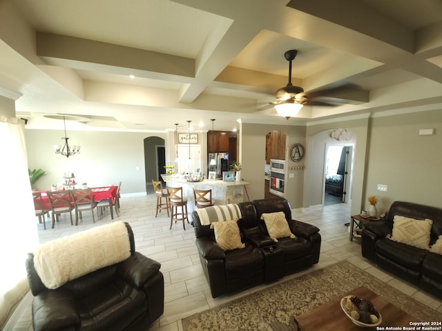 tiled living room with coffered ceiling and ceiling fan with notable chandelier