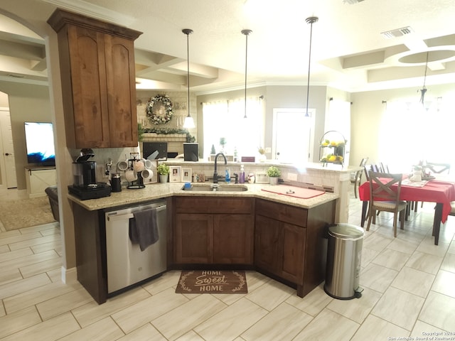 kitchen featuring backsplash, hanging light fixtures, sink, and dishwasher