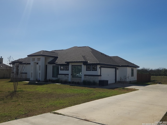 view of front of property with a front lawn and a garage