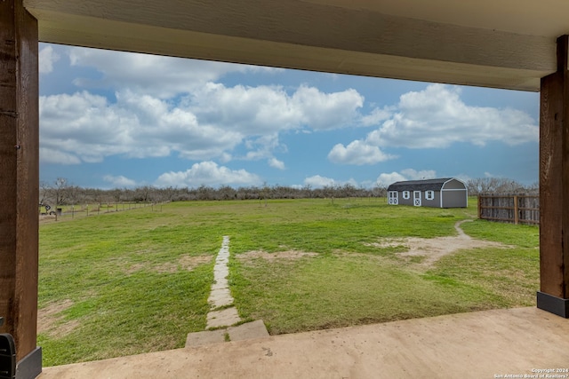 view of yard featuring an outdoor structure and a rural view