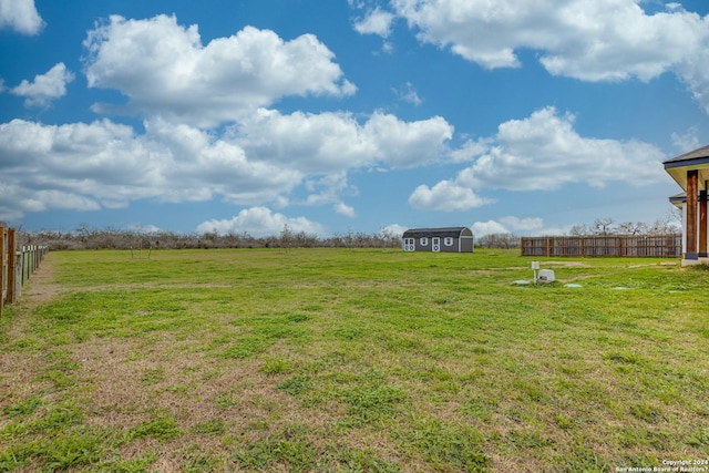 view of yard with a rural view and a shed