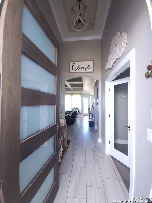 corridor featuring ornamental molding, light tile floors, and french doors