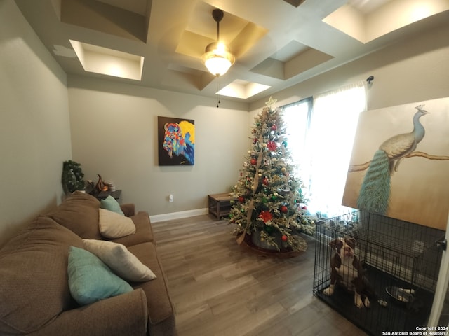 living room with coffered ceiling, dark hardwood / wood-style floors, ceiling fan, and a healthy amount of sunlight