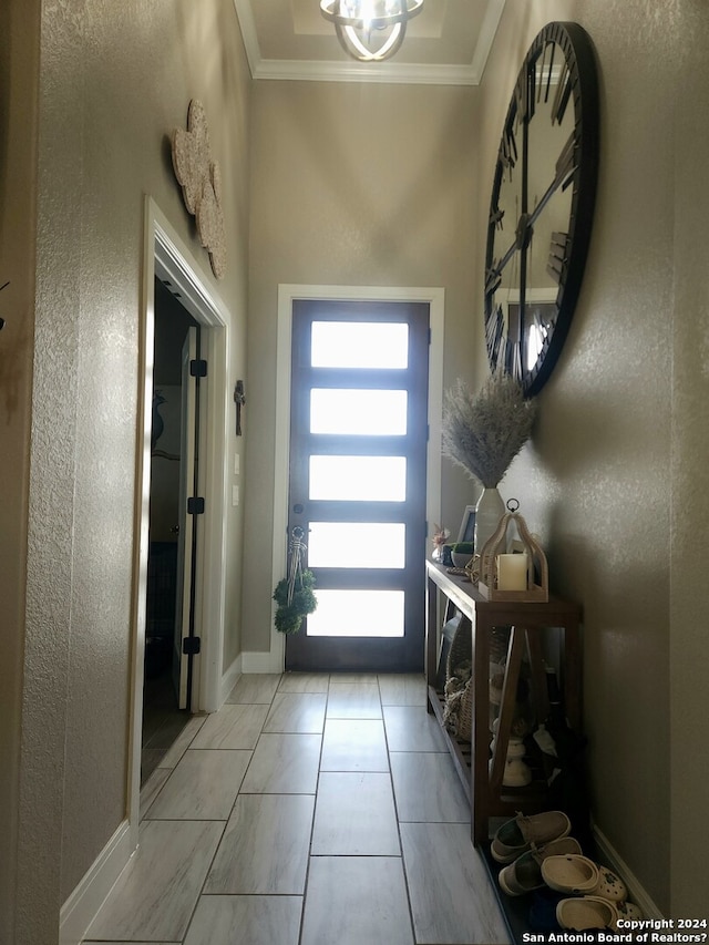 tiled foyer entrance with crown molding