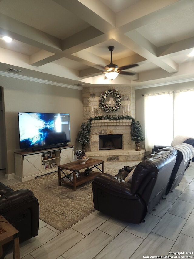 living room with coffered ceiling, ceiling fan, beam ceiling, and a stone fireplace