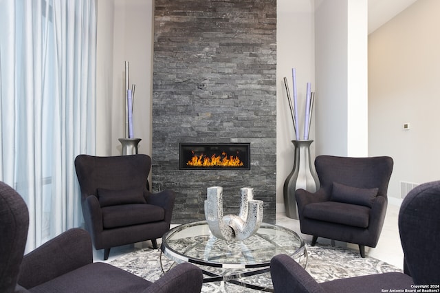 living room featuring a stone fireplace