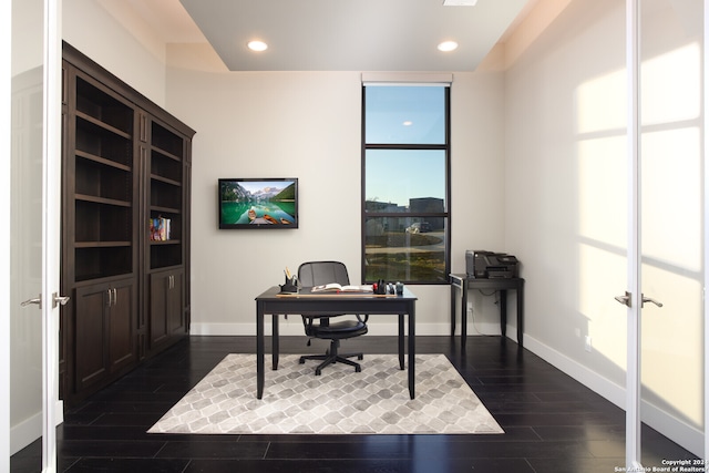 office area with french doors, floor to ceiling windows, and dark wood-type flooring