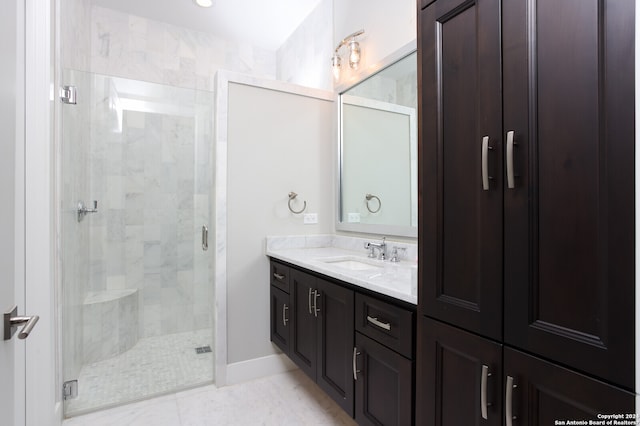 bathroom featuring walk in shower, vanity with extensive cabinet space, and tile flooring