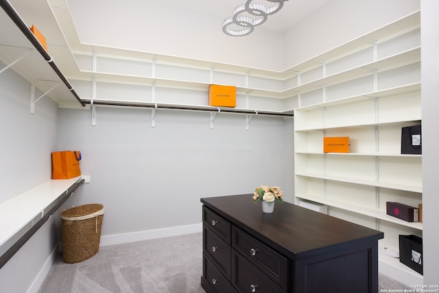 spacious closet featuring light carpet