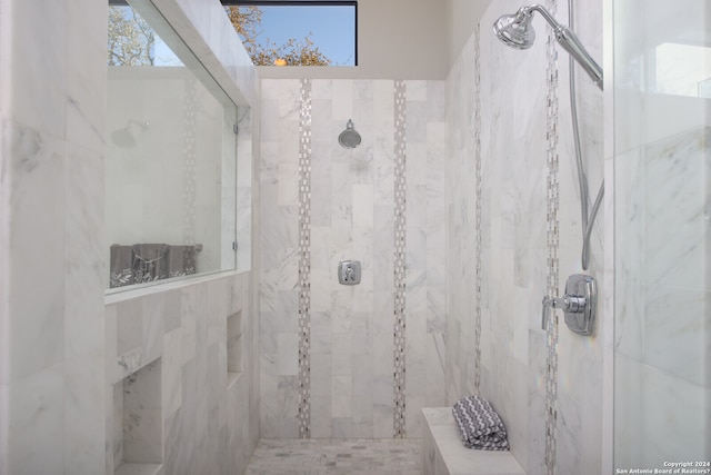 bathroom featuring tile walls and tiled shower