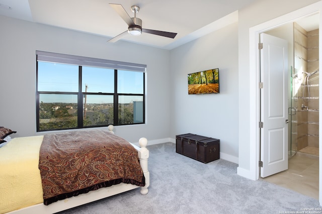 carpeted bedroom featuring connected bathroom and ceiling fan