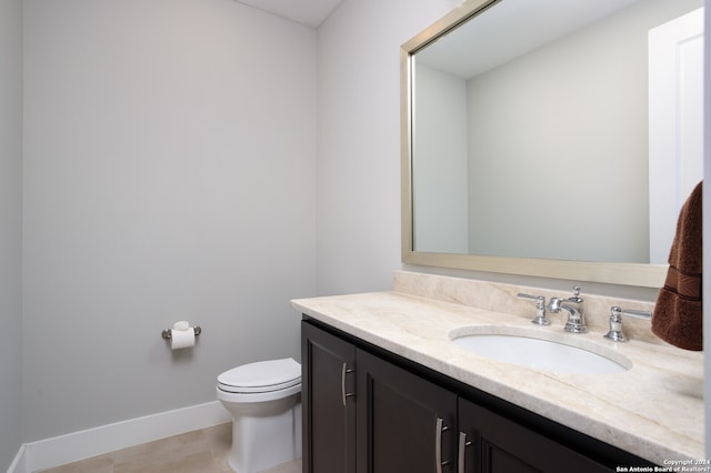 bathroom featuring tile flooring, oversized vanity, and toilet