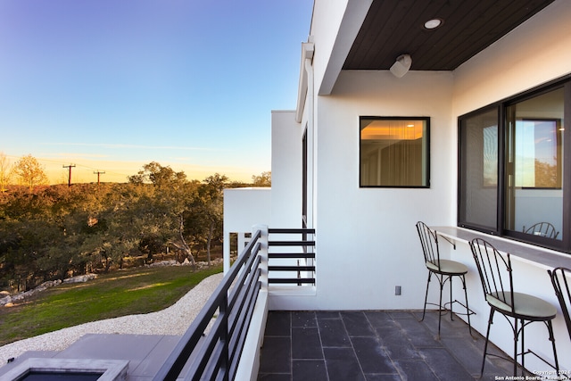 view of balcony at dusk