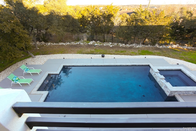 view of swimming pool with a patio area and an in ground hot tub