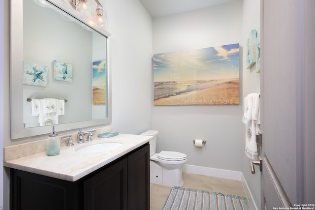 bathroom featuring tile flooring, oversized vanity, and toilet