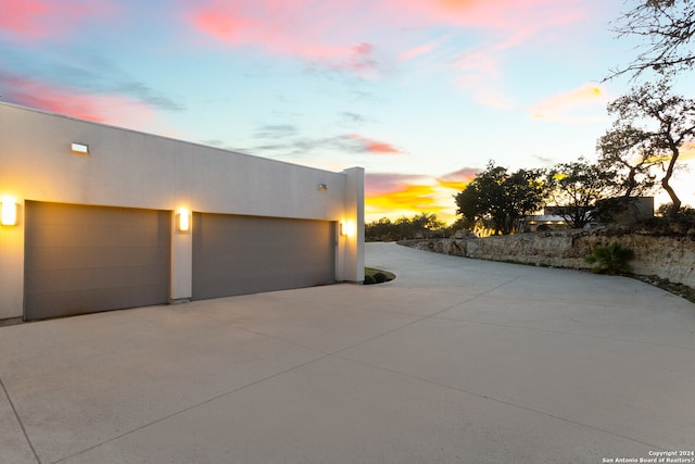 view of garage at dusk