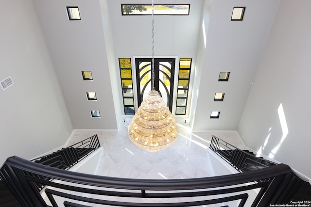 entryway with a high ceiling and a wealth of natural light