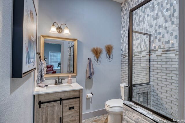 bathroom featuring toilet and vanity