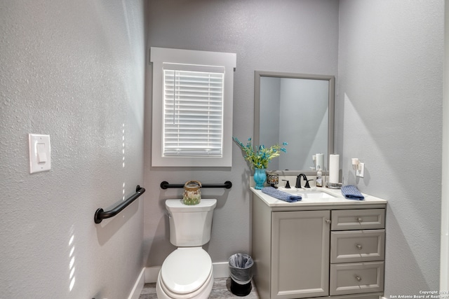 bathroom featuring toilet and vanity