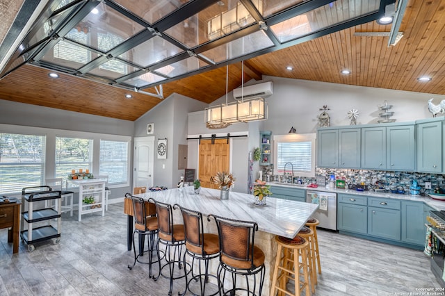 kitchen with wooden ceiling, decorative light fixtures, appliances with stainless steel finishes, and a breakfast bar