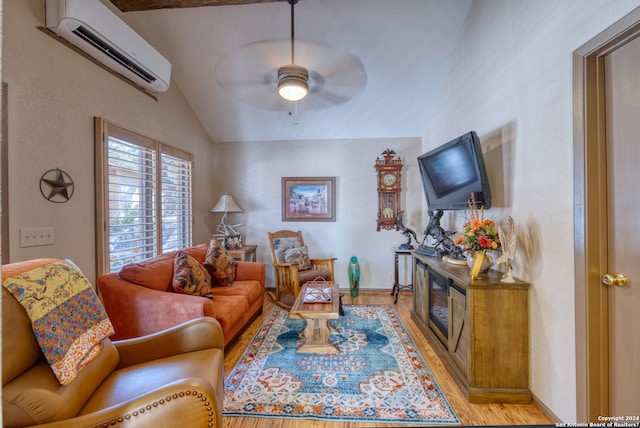 living room featuring ceiling fan, lofted ceiling, light hardwood / wood-style flooring, and a wall mounted air conditioner