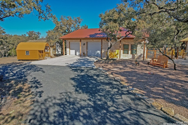 view of front of house with an outdoor structure and a garage