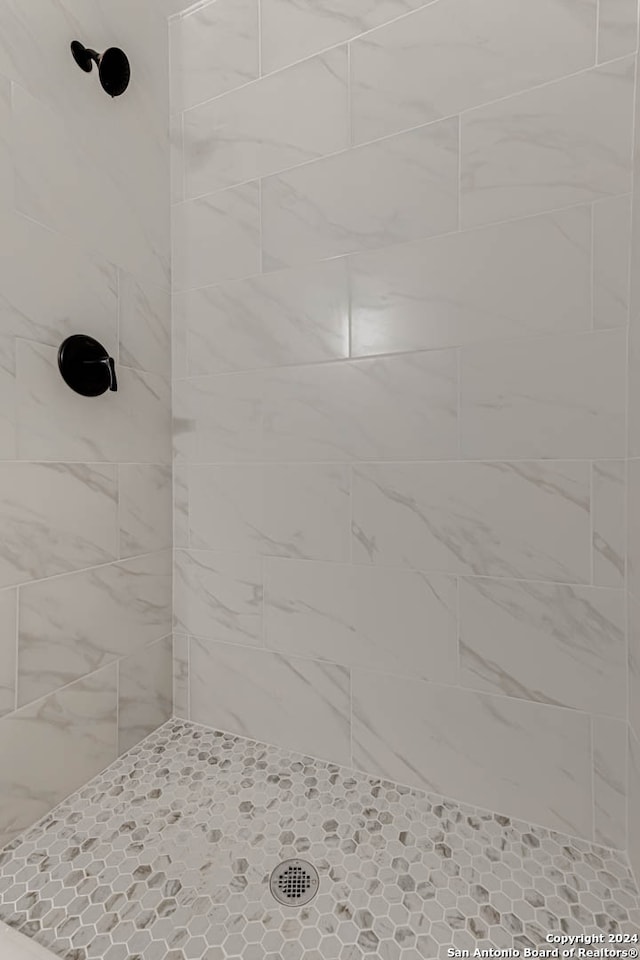 bathroom with a tile shower