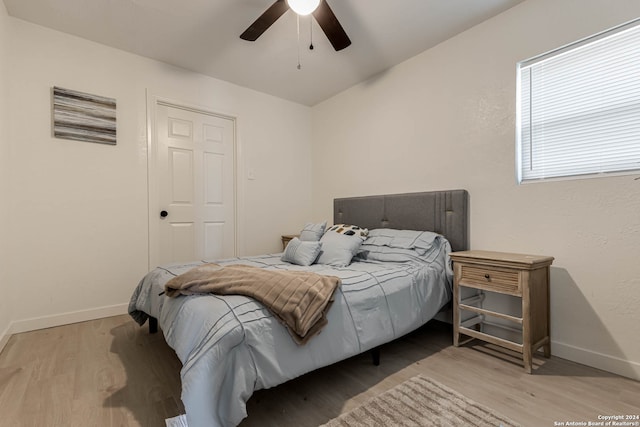 bedroom with ceiling fan and light hardwood / wood-style floors