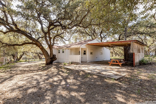 rear view of property featuring a carport