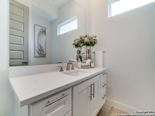 bathroom featuring tile flooring and vanity with extensive cabinet space
