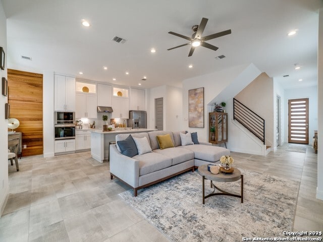 tiled living room featuring ceiling fan