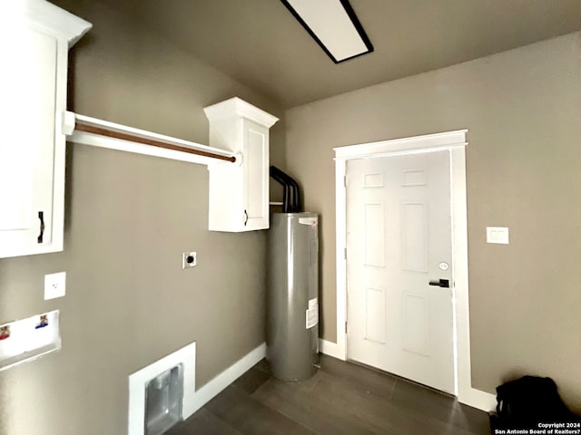 clothes washing area with cabinets, electric dryer hookup, electric water heater, and dark wood-type flooring