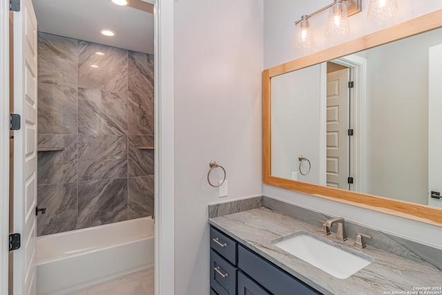 bathroom with vanity and tiled shower / bath