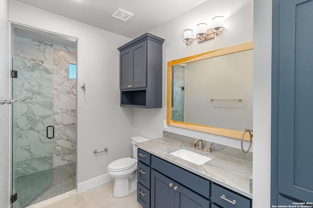 bathroom with tile patterned flooring, vanity, a shower with shower door, and toilet