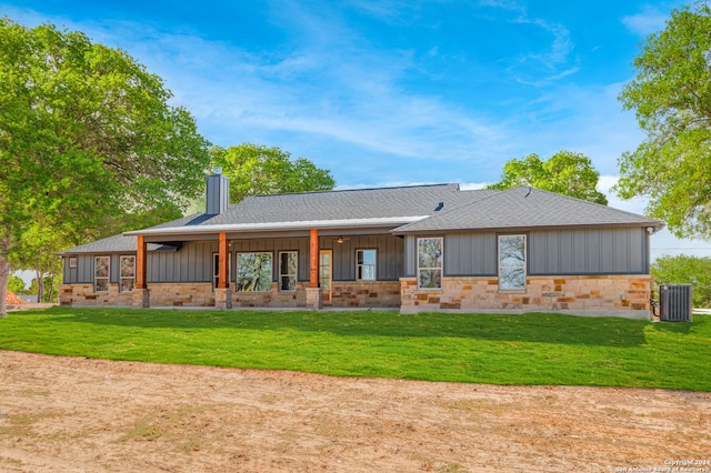 rear view of property with a yard, cooling unit, and a porch