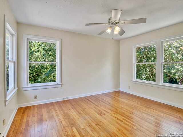 empty room featuring light wood-type flooring and ceiling fan