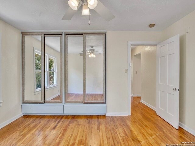 spare room with ceiling fan and light hardwood / wood-style flooring