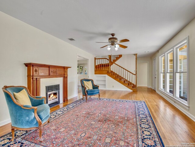 living room with ceiling fan and light hardwood / wood-style floors