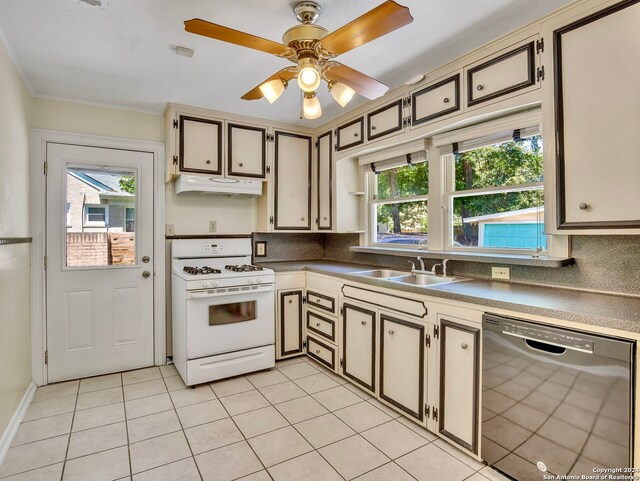 kitchen featuring ceiling fan, dishwasher, white gas range oven, light tile flooring, and sink