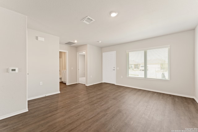 unfurnished room featuring dark hardwood / wood-style flooring