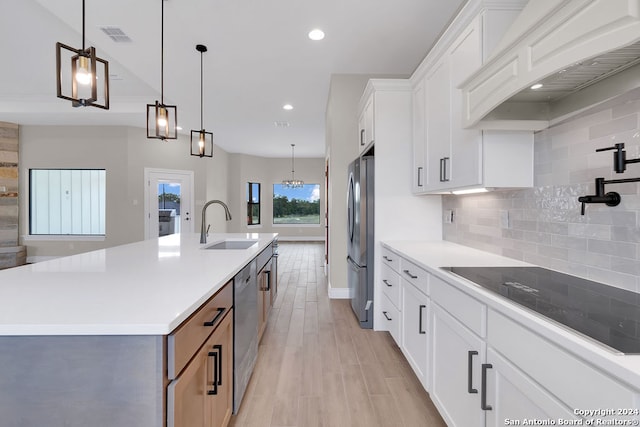 kitchen with white cabinetry, tasteful backsplash, a large island, and stainless steel appliances