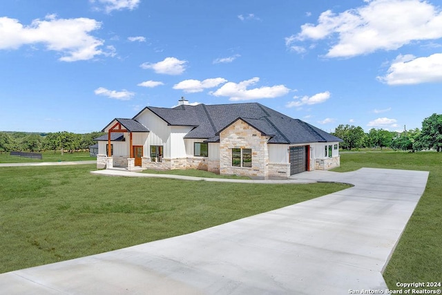 view of front facade with a garage and a front lawn