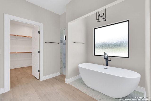 bathroom with a bathing tub and wood-type flooring